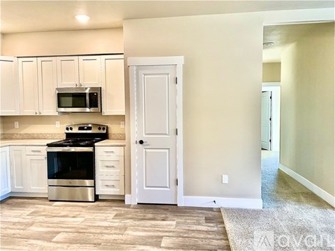 A kitchen with a stove, oven, and microwave.