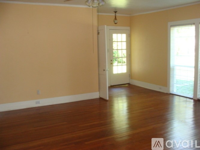 A room with wooden floors and a white door.