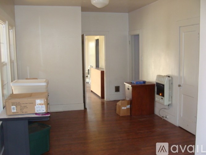 A room with a box on the floor and another box on the table.