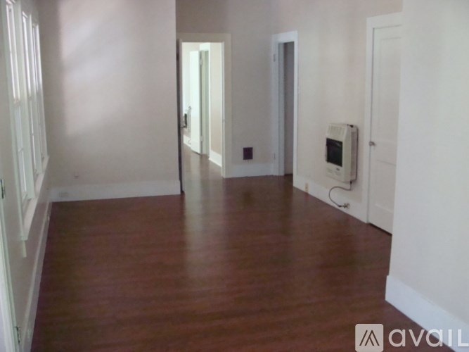 A room with wooden floors and white walls.