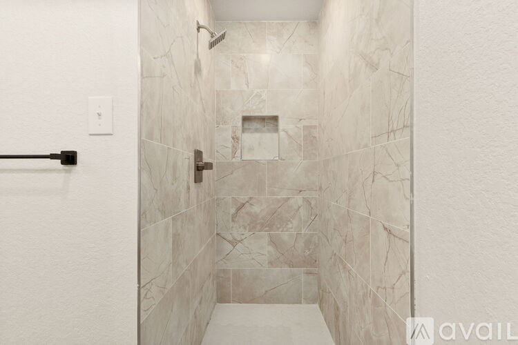 A bathroom with a marble tile shower.