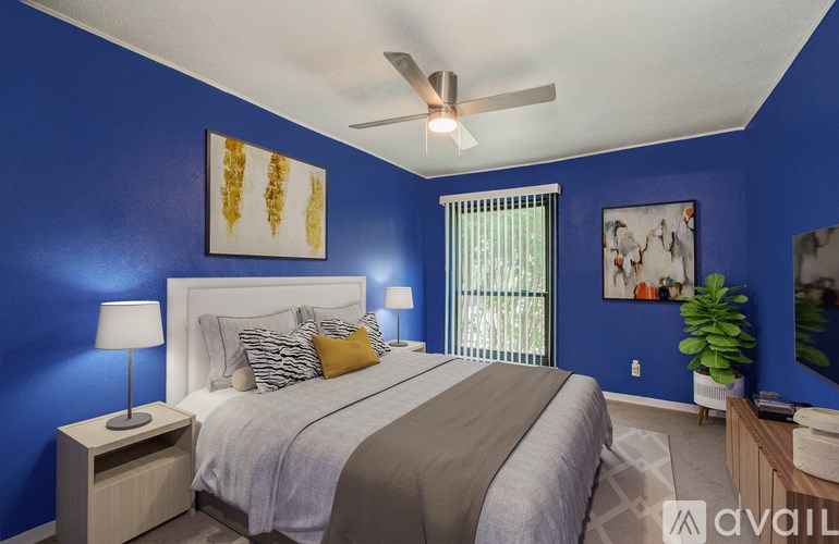 A bedroom with blue walls and a large bed.
