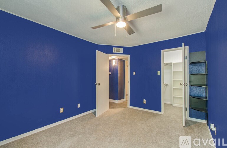 A room with blue walls and a ceiling fan.