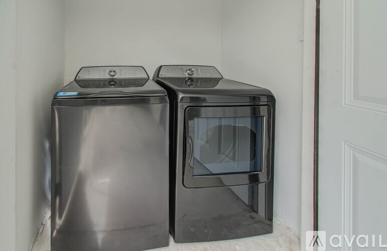 Two black microwaves are placed next to each other.