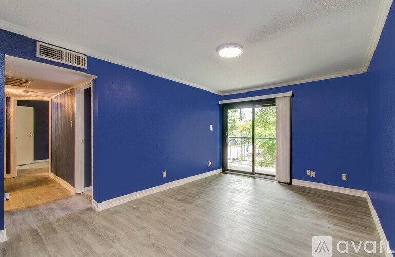 A room with blue walls and wooden flooring.