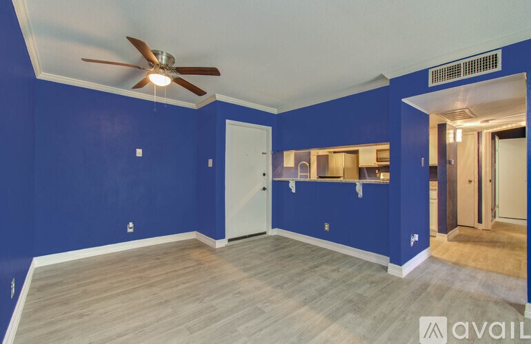A room with blue walls and a ceiling fan.