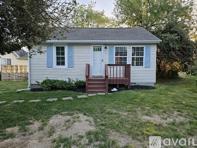 A small house with a blue door and a porch.