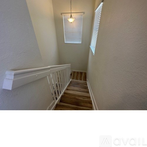 A stairway with wooden steps and white railings.