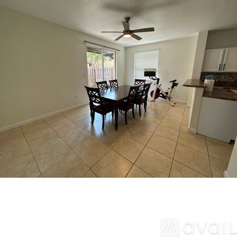 A kitchen area with a dining table and chairs.