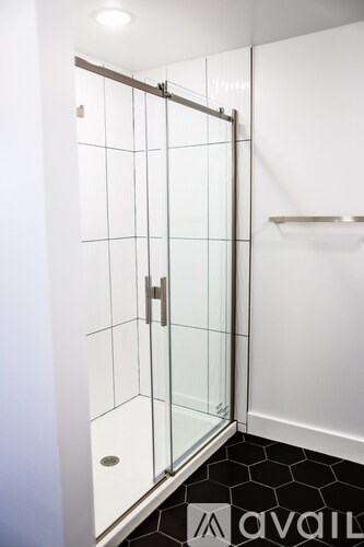 A glass door with a handle and a shelf on the other side.