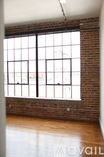 A large window with a view of a street and buildings outside.