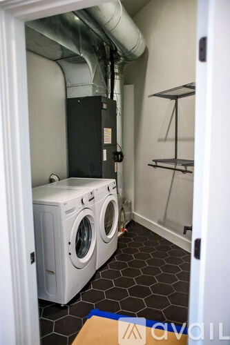 A small laundry room with a washer and dryer.