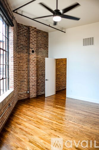A room with a wooden floor and a ceiling fan.