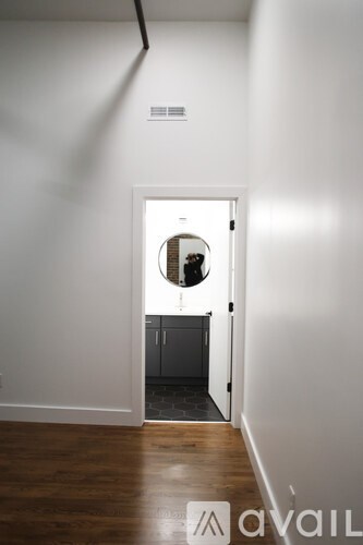 A white door with a round window in the middle.