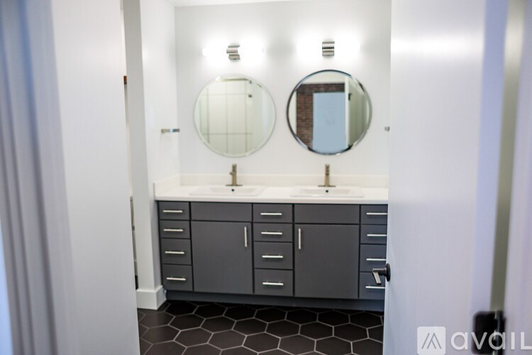 A bathroom with two sinks and two mirrors.