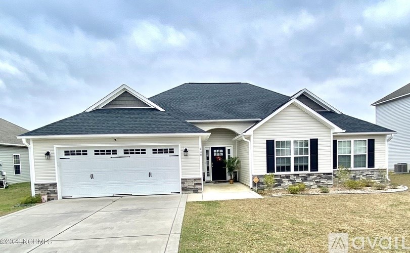 A two-story house with a garage and a front porch.