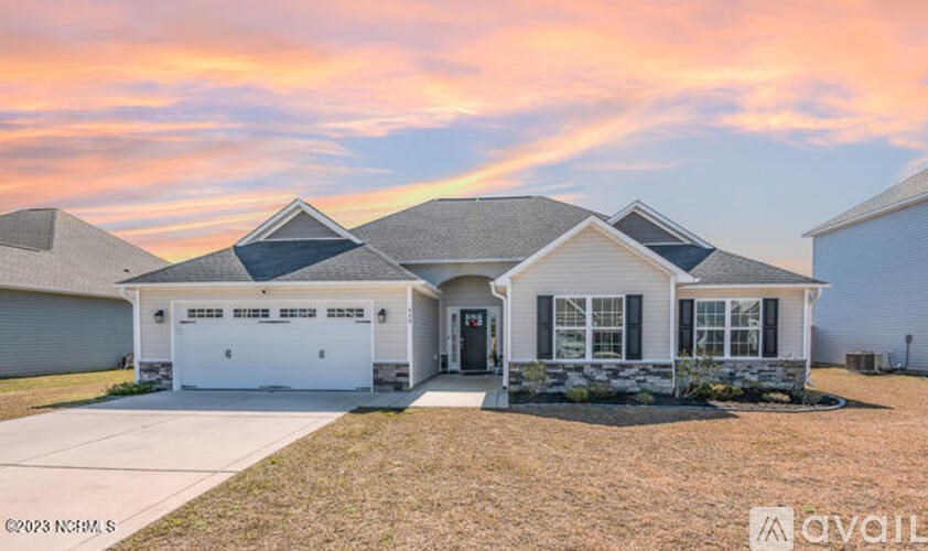 A house with a garage and a driveway is shown in the image.