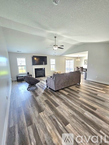 A living room with a grey couch and a television.