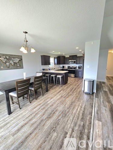 A modern kitchen with a dining table and chairs.