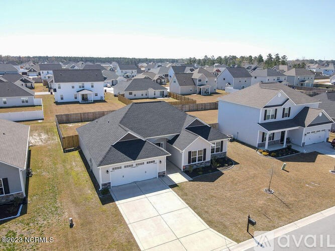 A bird's eye view of a residential area with houses and a playground.