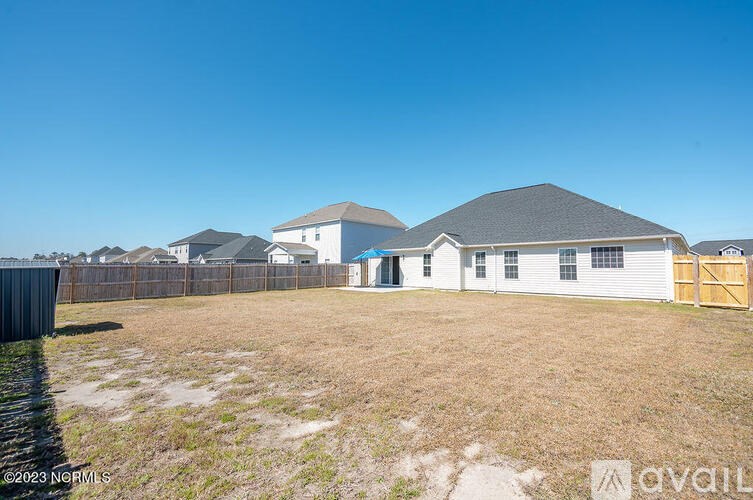 A row of houses with a fence in front of them.