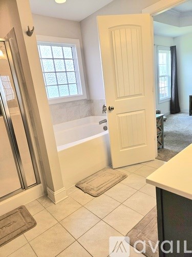 A bathroom with a tub, toilet, and sink.