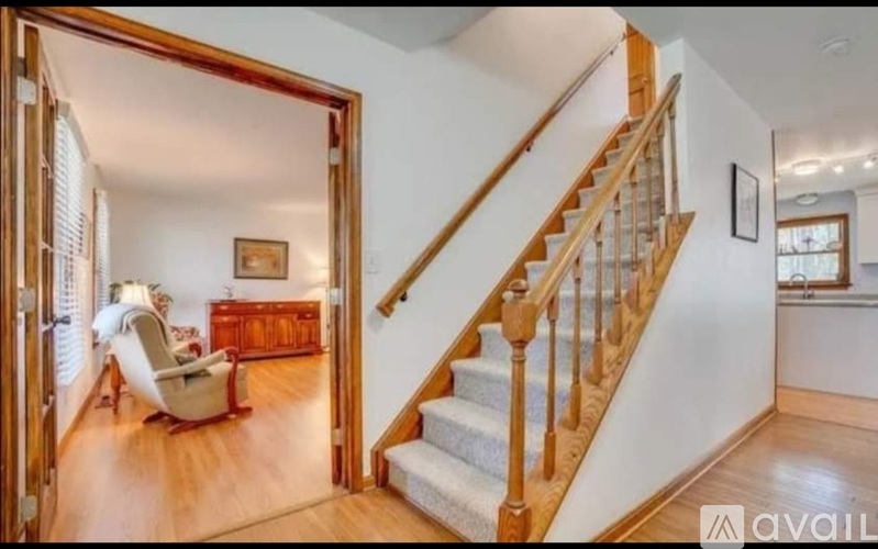 A living room with a staircase leading to the upper floor.