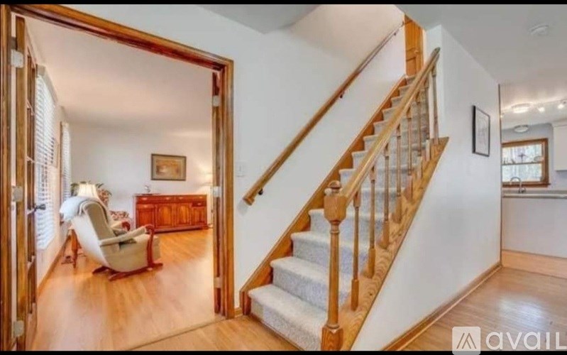 A living room with a staircase leading to the upper floor.