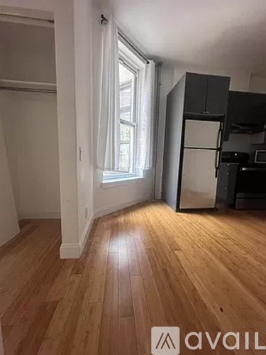 A room with wooden floors and a window.