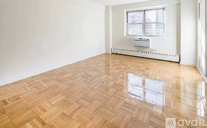 A room with wooden flooring and a window.