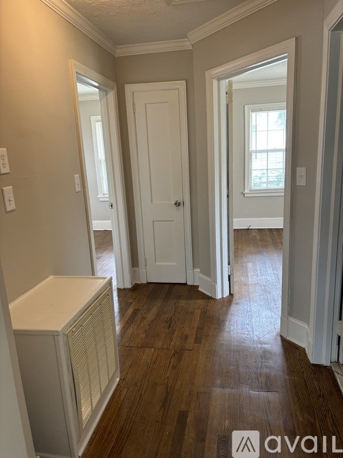 A room with a white door and a window.