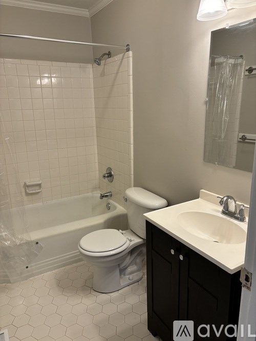 A bathroom with a white toilet, sink, and bathtub.