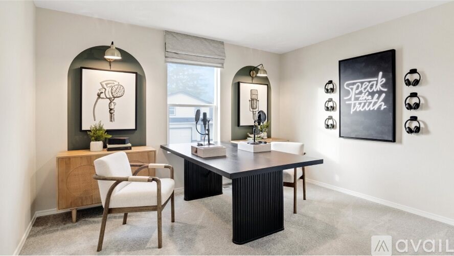 A room with a desk, chair, and a wall hanging that says "Speak Truth".