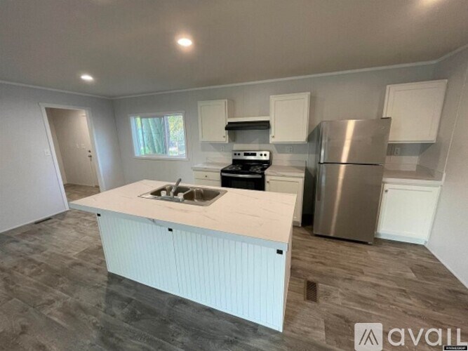 A kitchen with a white countertop and stainless steel appliances.