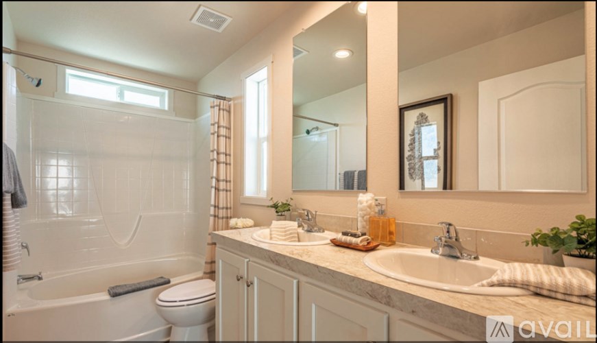 A bathroom with a white toilet, a white bathtub, and a white sink.