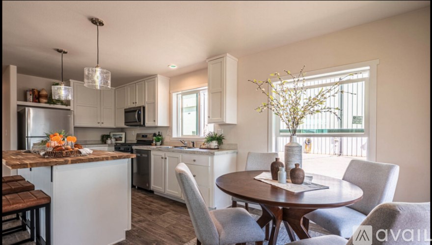 A modern kitchen with a dining table set for four.
