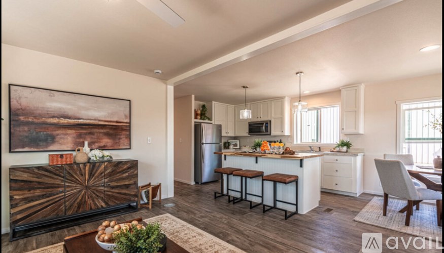 A modern kitchen with a wooden table and chairs.