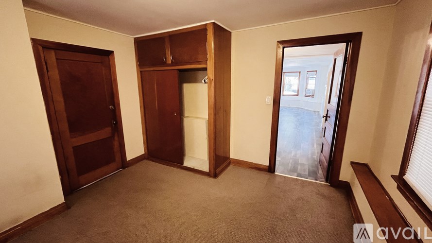 A room with a brown carpet and a brown door.
