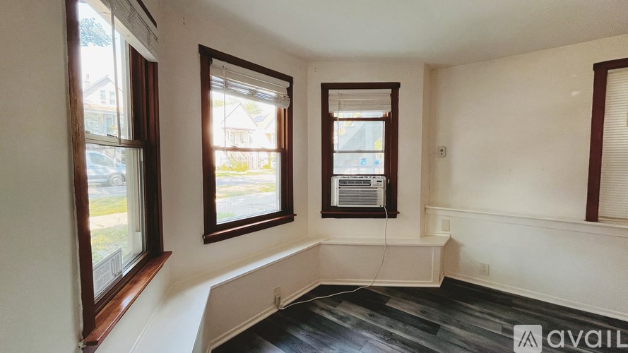 A room with two windows and a floor heating system.