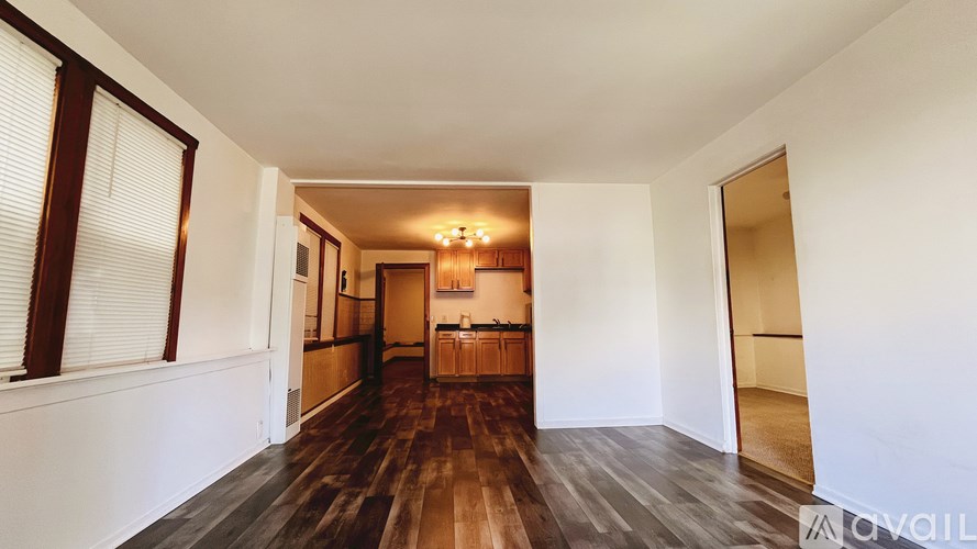 A room with wooden floors and white walls.