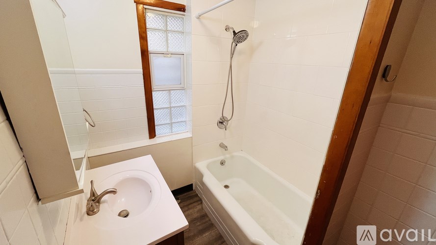 A bathroom with a white sink and a bathtub.