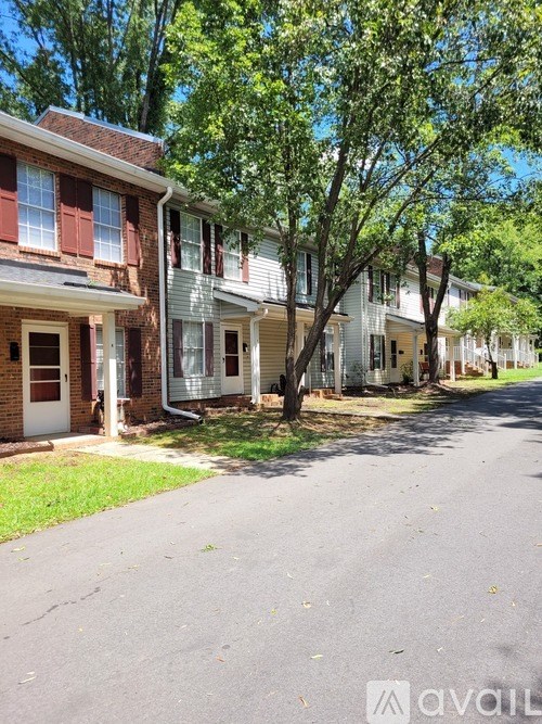 A street view of a residential area with houses on both sides.
