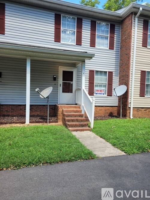 A house with a satellite dish on the roof.