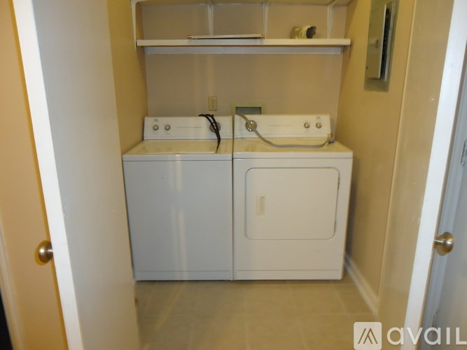 A small white bathroom with a sink and a cabinet.