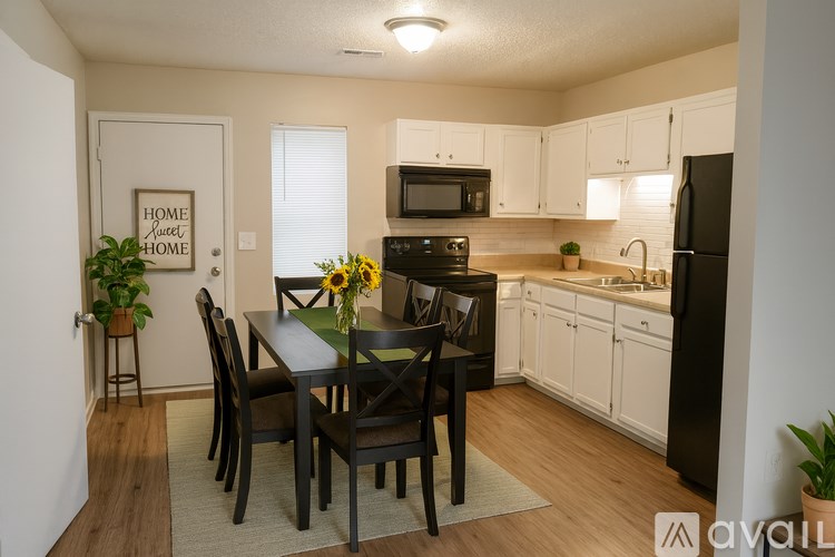 A kitchen with a dining table and chairs.
