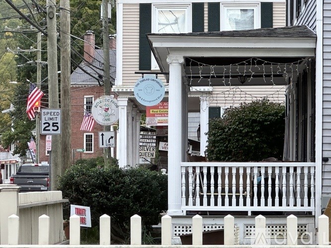 A house with a porch and a sign that says "SPEED LIMIT 25".