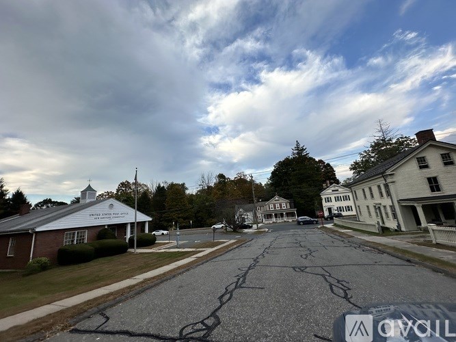 A street view with a church and houses on the side.