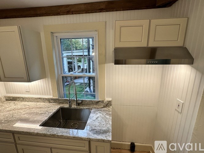 A kitchen with a sink and a window.
