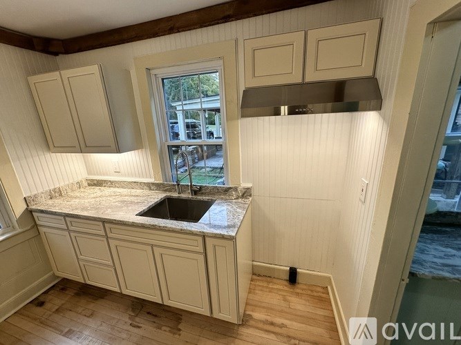 A kitchen with a sink and a window.