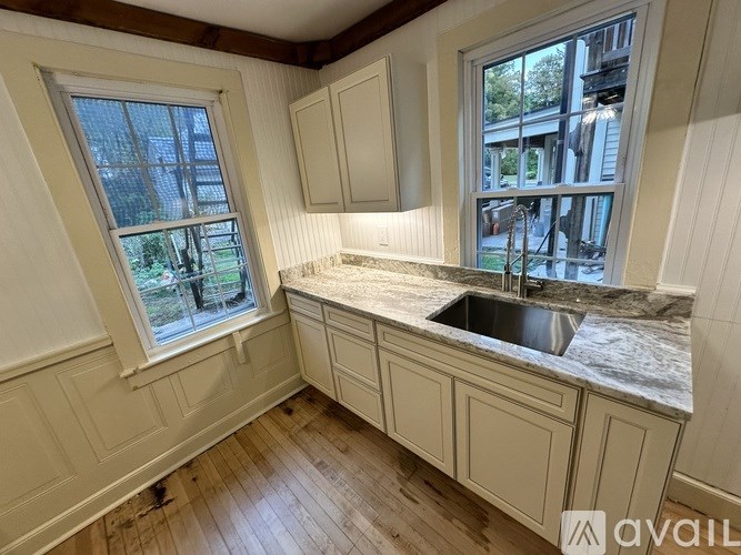 A kitchen with a sink and a window.